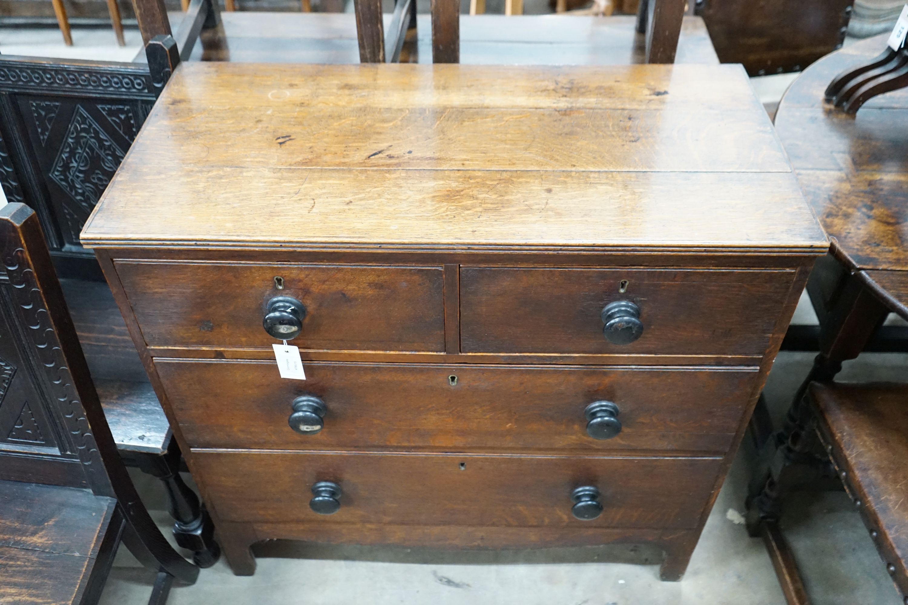 A small Regency provincial oak chest of two short and two long drawers, width 90cm, depth 44cm, height 89cm